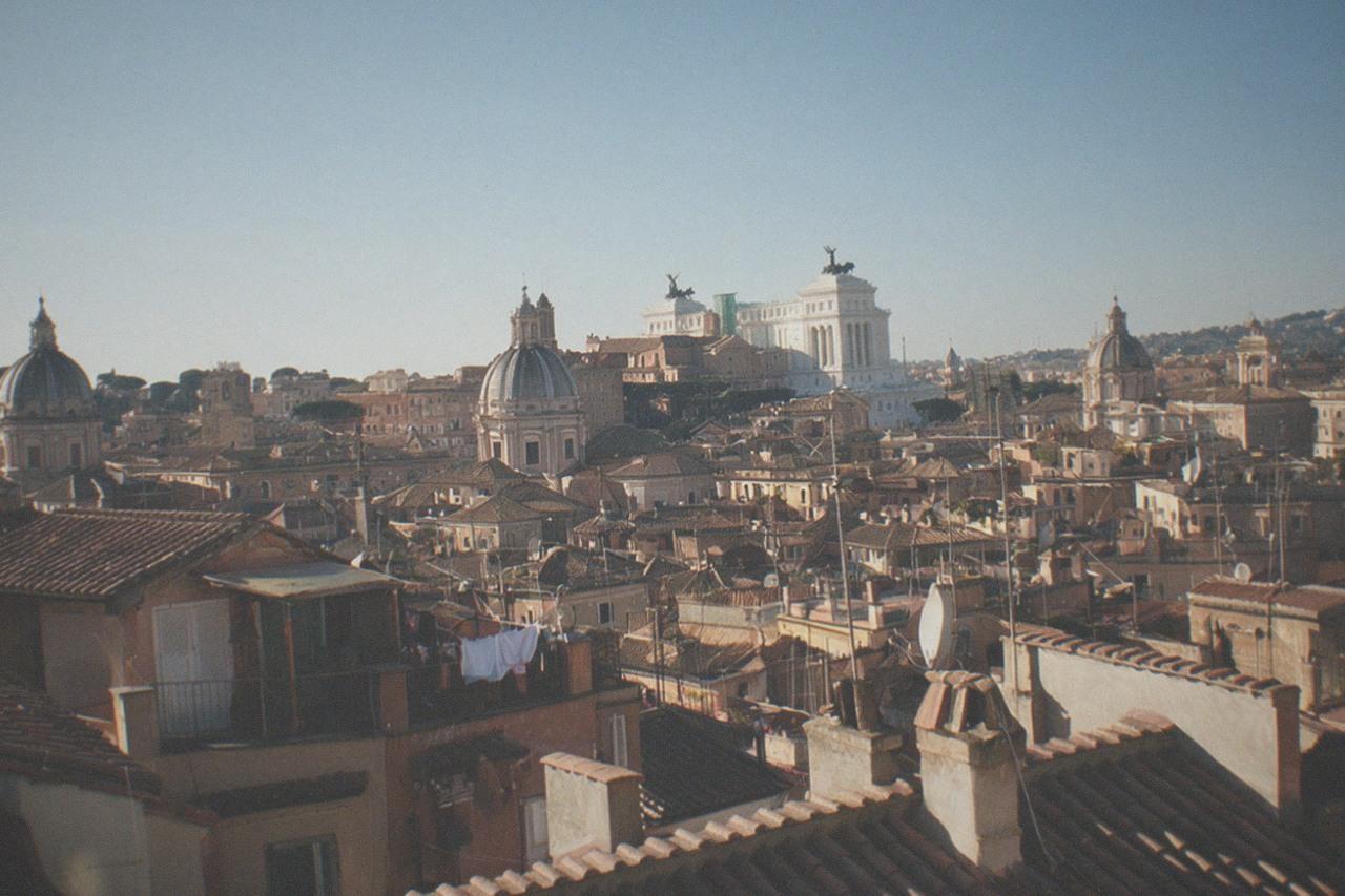 Rooftops and church domes of central Rome under a clear morning sky