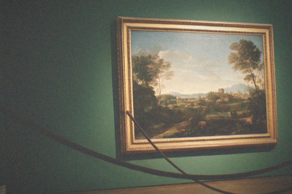 Renaissance painting displayed on a dark gallery wall with ornate frame