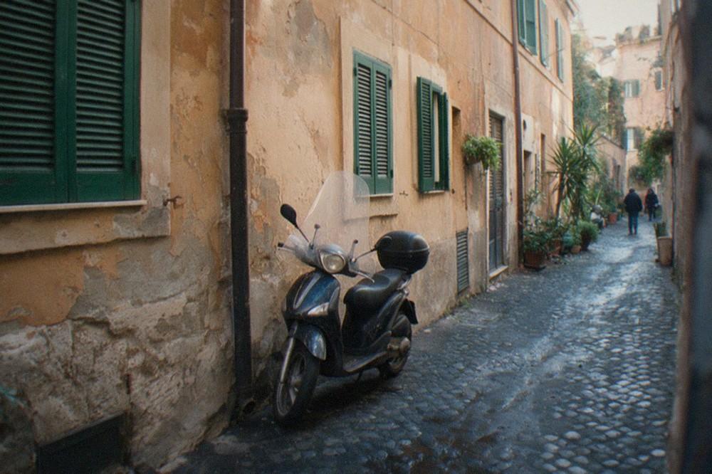 Quiet Roman street in January with closed shutters and soft winter light on old stone buildings