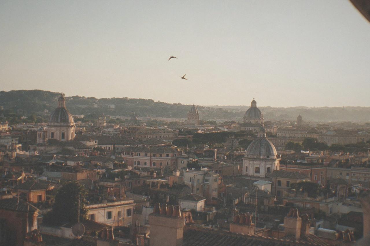 Warm golden light over the rooftops and domes of Rome at sunset