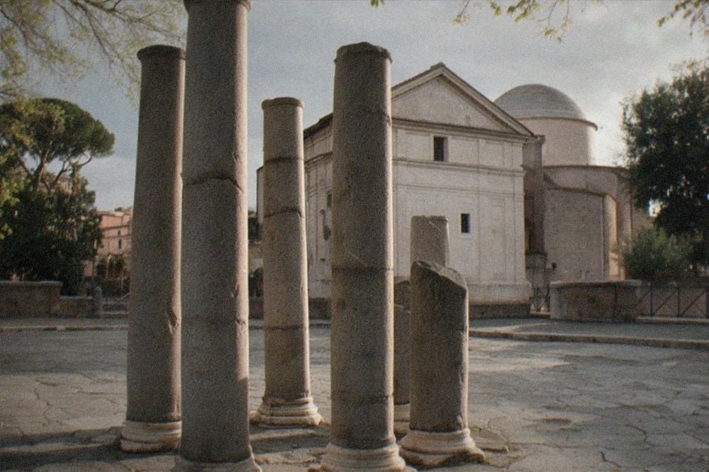 Ancient granite columns standing in a Rome square in late afternoon sun