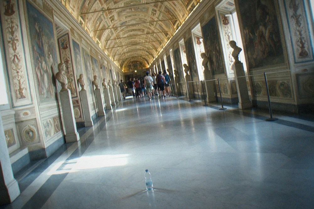 The Vatican Museums gallery interior with frescoed ceiling and marble floors