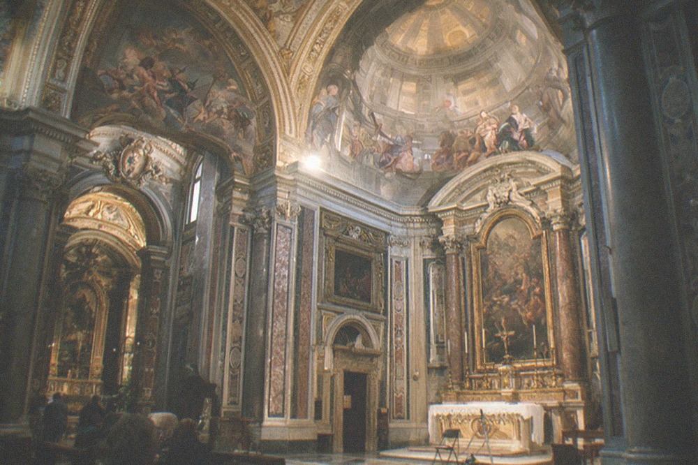 Baroque church interior with painted ceiling lit softly in the evening