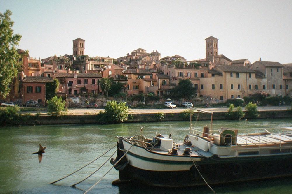 Stone bridge over the Tiber with Trastevere rooftops beyond