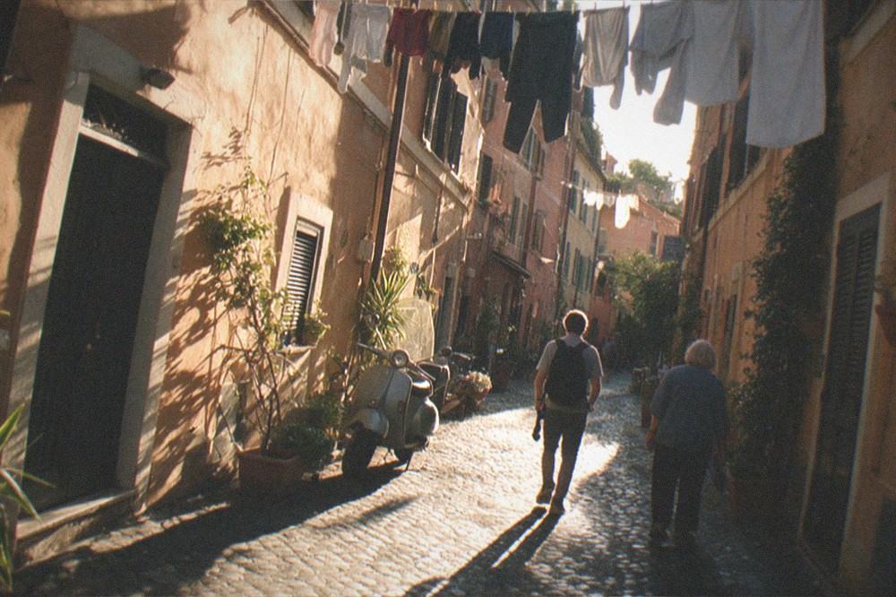 Golden evening light on ochre walls and cobbles in a quiet lane