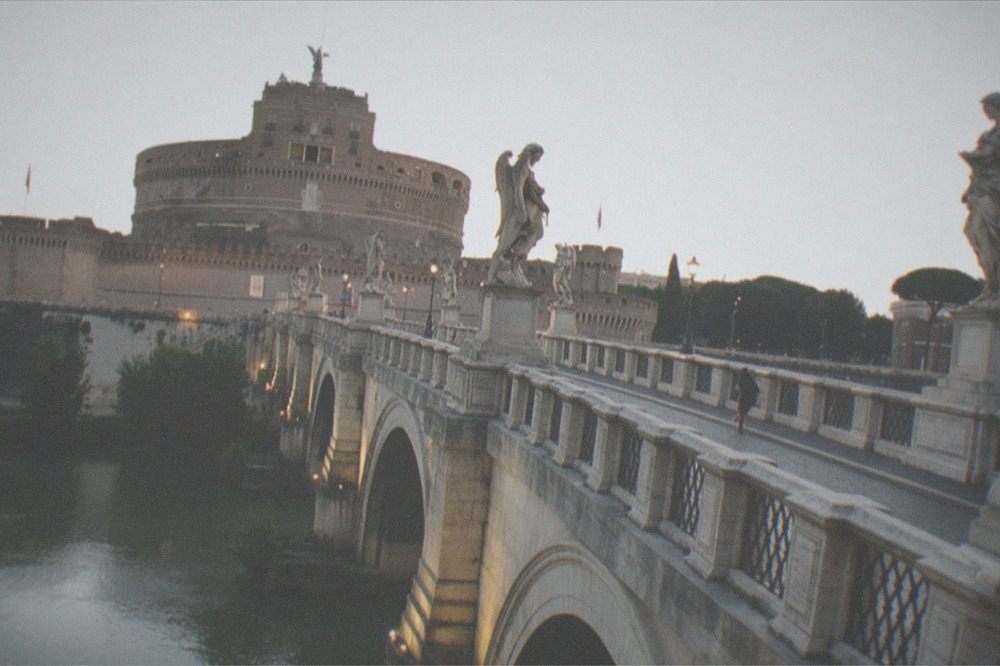 Ponte Sant'Angelo bridge over the Tiber with angel statues and Castel Sant'Angelo behind