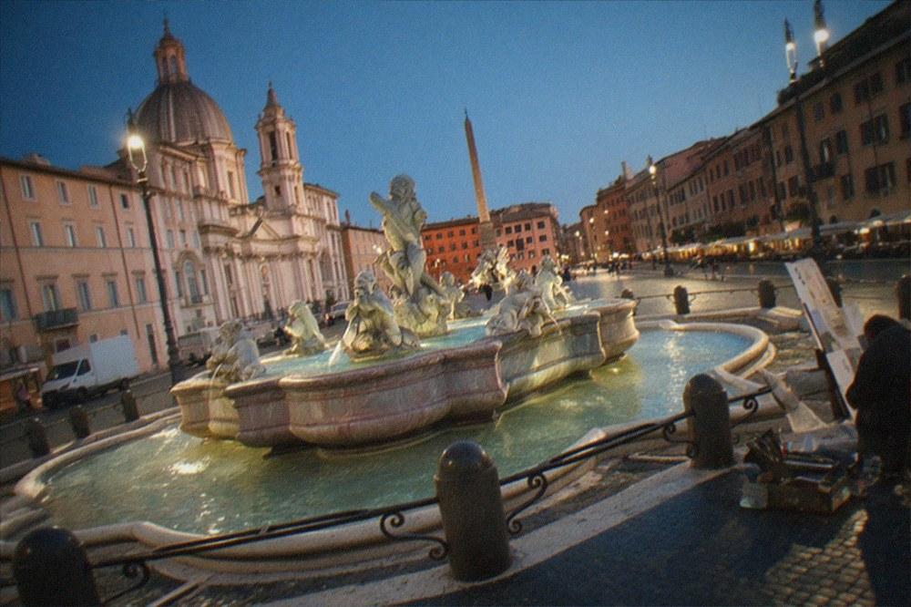 Baroque fountain and painted facades around a Roman piazza at golden hour