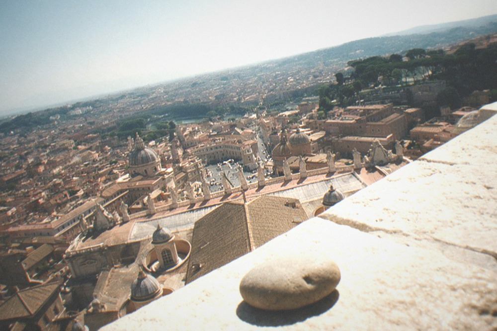 View over Rome rooftops from the dome of St Peter's Basilica at midday