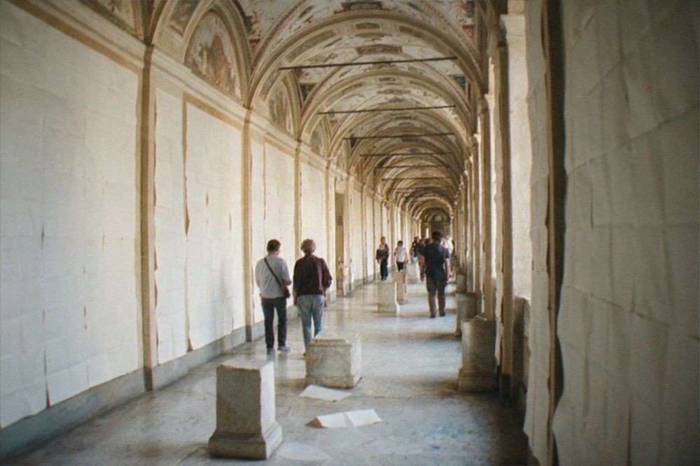 Long gallery of the Vatican Museums with frescoed ceiling and map-lined walls
