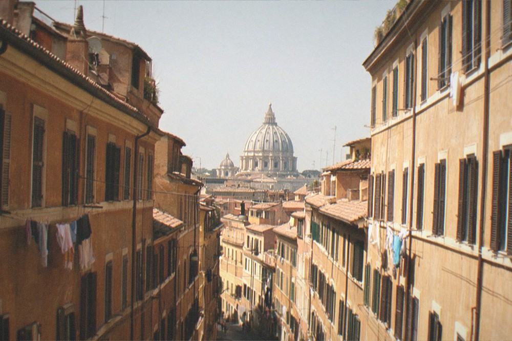 The dome of St Peter's Basilica rising above rooftops in the distance