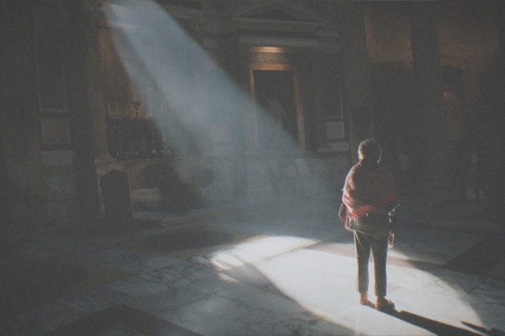 Sunlight beam crossing the dark interior of the Pantheon rotunda