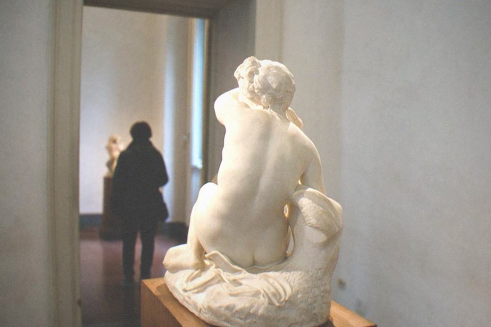 Sculpture displayed in a museum gallery inside Villa Borghese