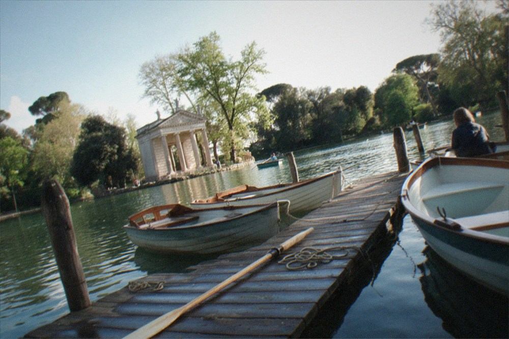 Rowing boats moored at the lake with the small temple on its island